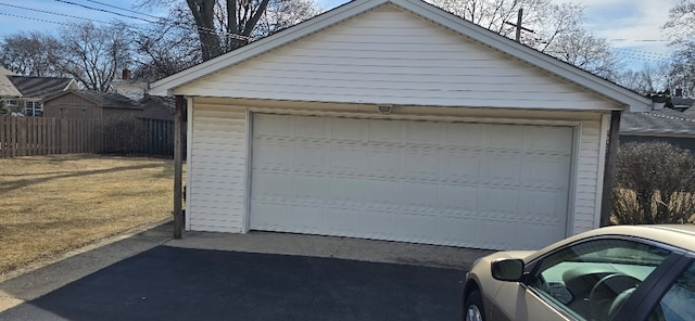 detached garage featuring fence