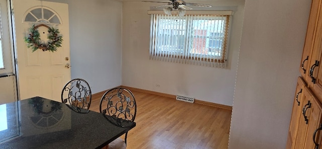 dining space with visible vents, baseboards, light wood-style floors, and a ceiling fan