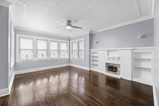 unfurnished living room with a ceiling fan, wood finished floors, baseboards, a textured ceiling, and a brick fireplace