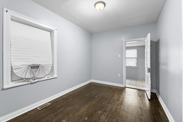 8025 S Evans Ave, Chicago, IL 60619 - spare room with visible vents, wood-type flooring, and baseboards