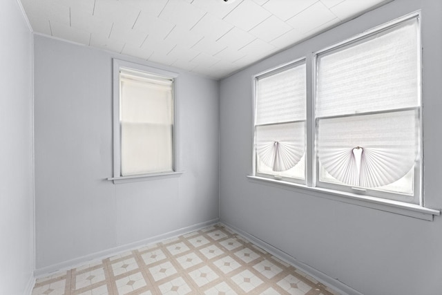 8025 S Evans Ave, Chicago, IL 60619 - spare room featuring light floors, baseboards, and a wealth of natural light