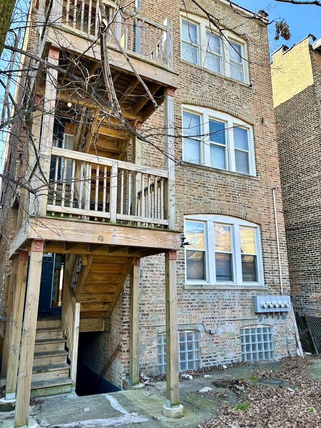 back of house with cooling unit and brick siding