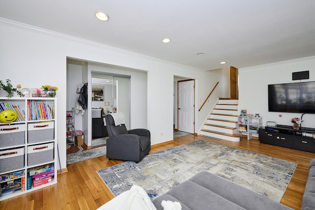 living room with recessed lighting, ornamental molding, stairs, and hardwood / wood-style flooring