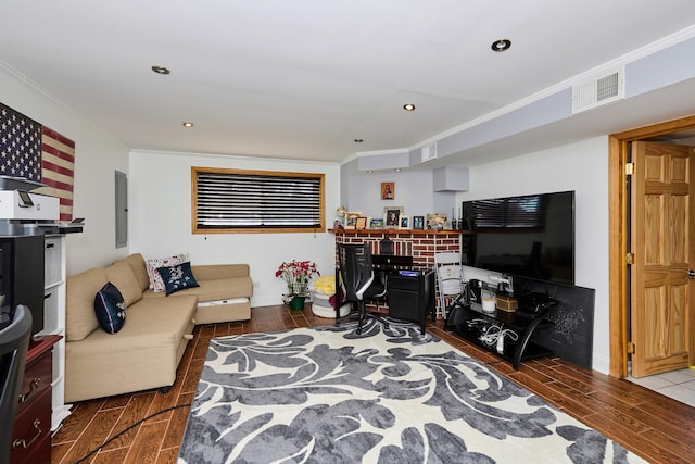 living room with ornamental molding, visible vents, and wood tiled floor