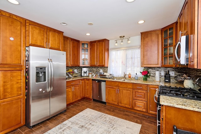 kitchen with a sink, brown cabinets, and appliances with stainless steel finishes