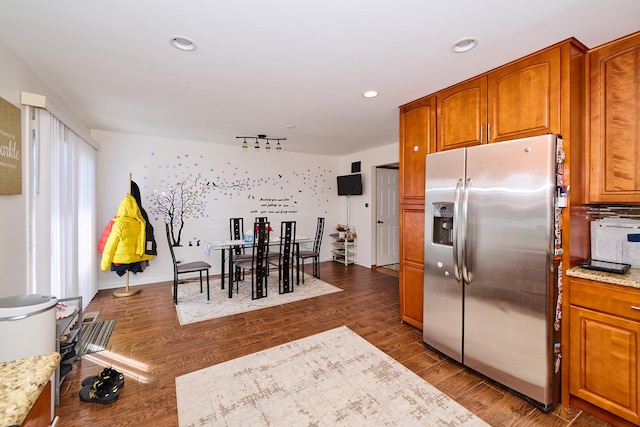 kitchen featuring dark wood-style floors, recessed lighting, brown cabinets, and stainless steel fridge with ice dispenser