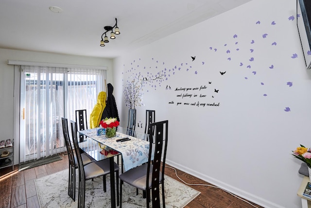 dining area with wood finished floors and baseboards