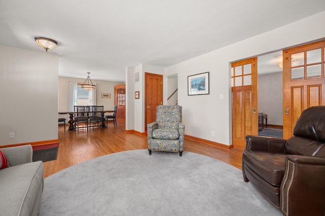 living area featuring wood finished floors and baseboards