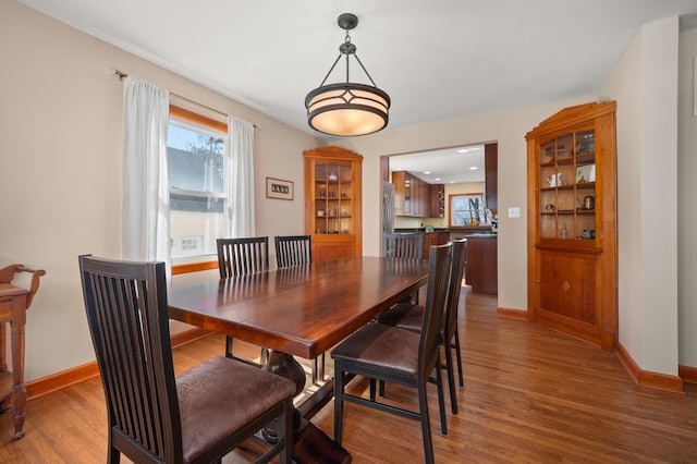 dining room with baseboards and wood finished floors