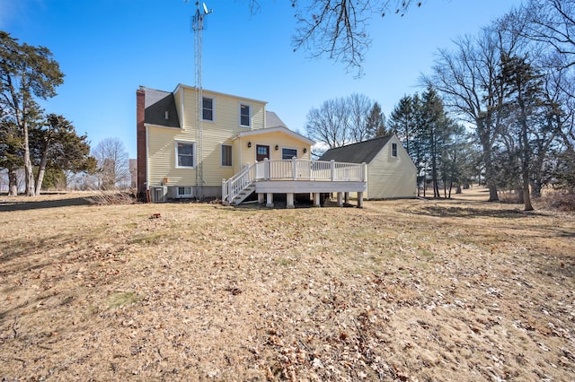 rear view of property with cooling unit, a chimney, and a deck