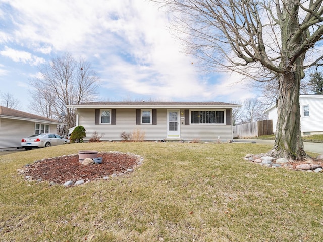 single story home with a front yard and fence