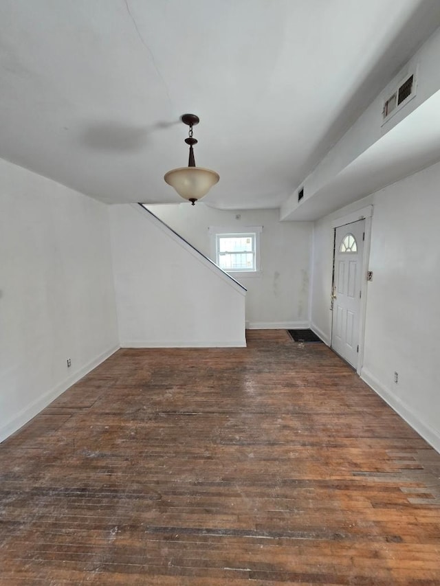 foyer with visible vents, baseboards, and hardwood / wood-style flooring