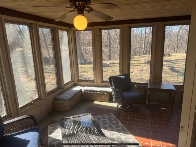 sunroom featuring a ceiling fan