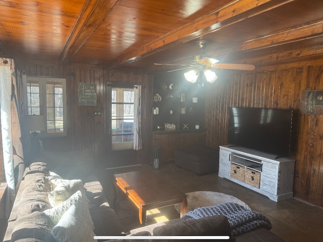 living area featuring beam ceiling, wooden walls, radiator, and wood ceiling