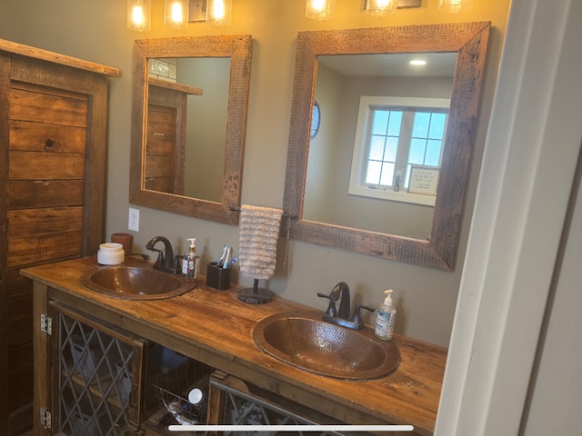 full bathroom with a sink and double vanity