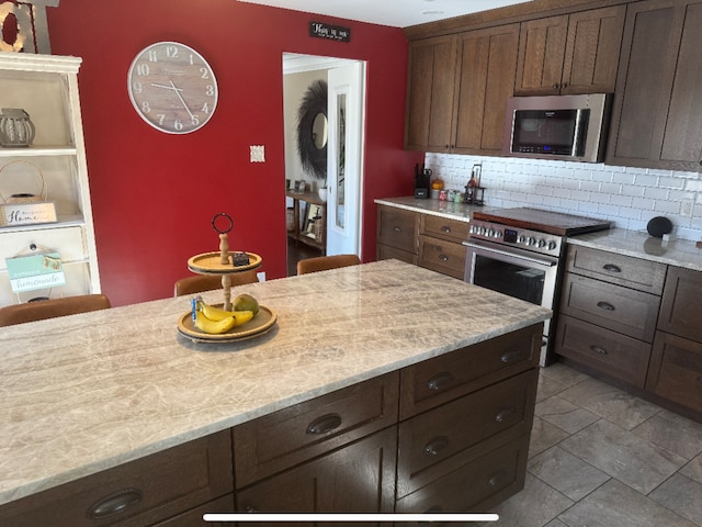 kitchen with stainless steel appliances and backsplash