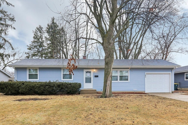 ranch-style home with concrete driveway, a chimney, a garage, and a front lawn