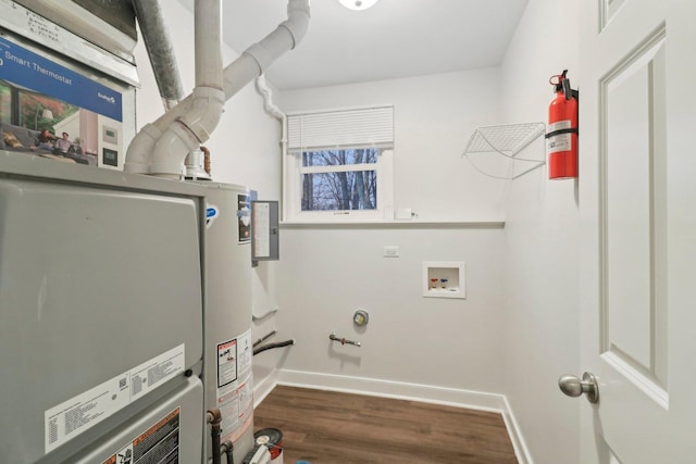 laundry room featuring water heater, laundry area, baseboards, and dark wood-style flooring