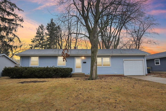 ranch-style home featuring a front lawn, a garage, driveway, and a chimney