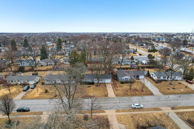 single story home with a residential view, a front yard, roof with shingles, a garage, and driveway