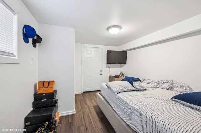 bedroom featuring wood finished floors and baseboards