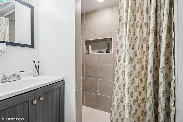 bathroom featuring vanity and a tile shower