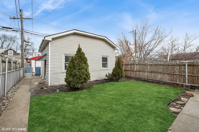 exterior space with a lawn and a fenced backyard