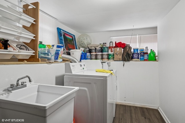 laundry room featuring laundry area, independent washer and dryer, a sink, and wood finished floors