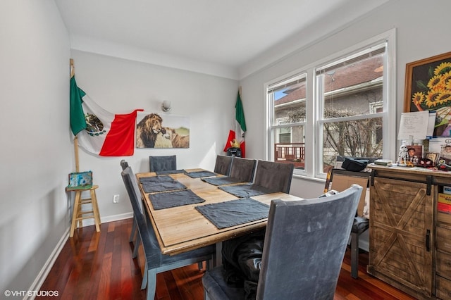 dining room featuring wood finished floors and baseboards