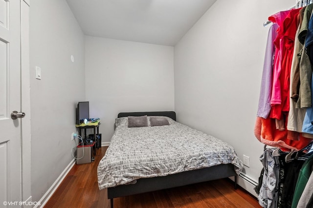 bedroom with baseboards and wood finished floors