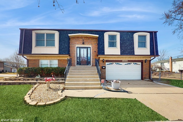 raised ranch with mansard roof, an attached garage, a shingled roof, concrete driveway, and brick siding