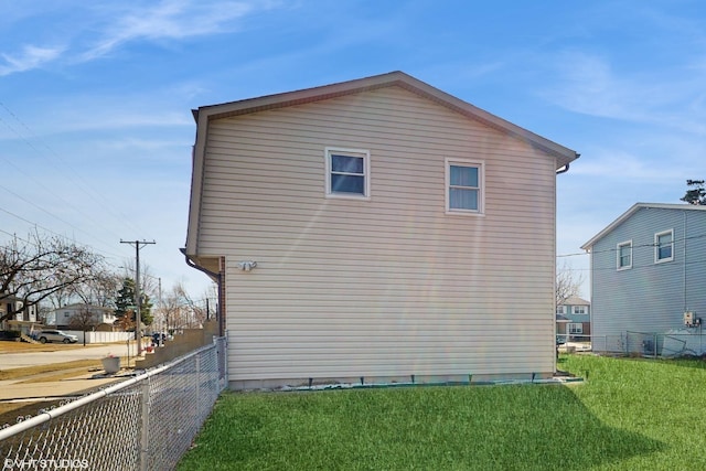 view of side of property featuring a yard and fence