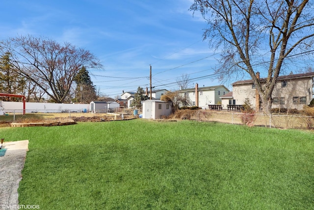 view of yard with an outbuilding, fence private yard, and a shed