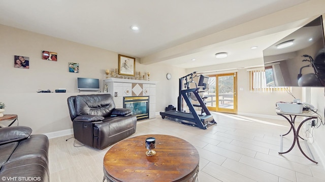 living area with recessed lighting, baseboards, and a fireplace