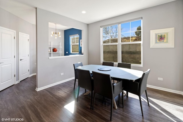 dining area with an inviting chandelier, wood finished floors, and baseboards