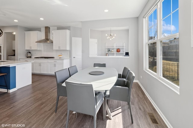 dining area with visible vents, baseboards, an inviting chandelier, and dark wood-style flooring