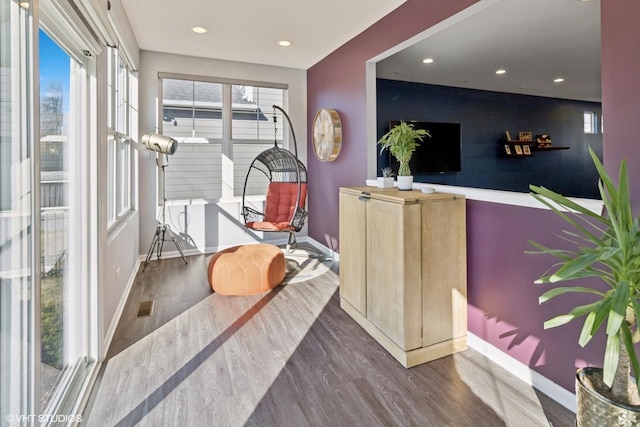 interior space with recessed lighting, wood finished floors, visible vents, and baseboards