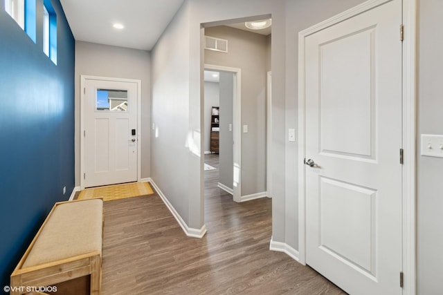 interior space featuring recessed lighting, wood finished floors, visible vents, and baseboards