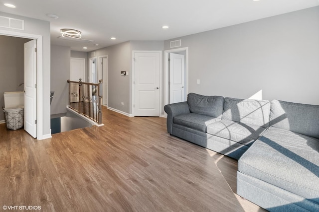 living area featuring visible vents, recessed lighting, and wood finished floors