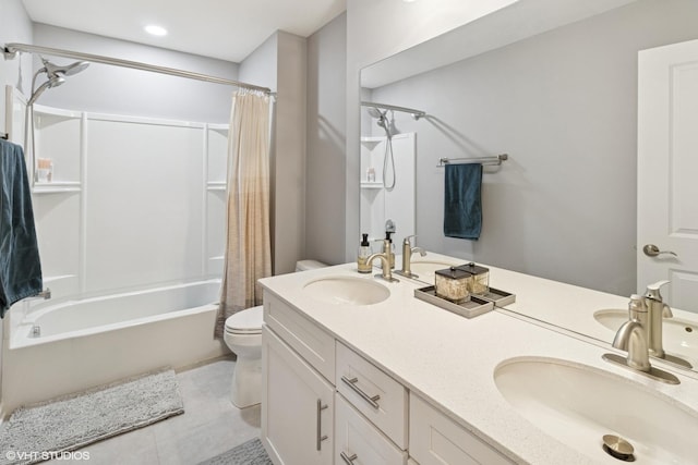 full bath with tile patterned flooring, toilet, shower / bath combo with shower curtain, and a sink