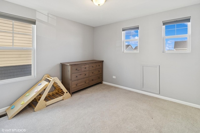 rec room with baseboards and carpet