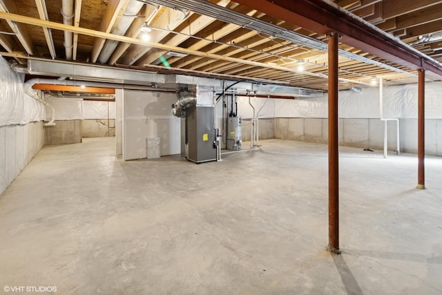 unfinished basement with heating unit and water heater