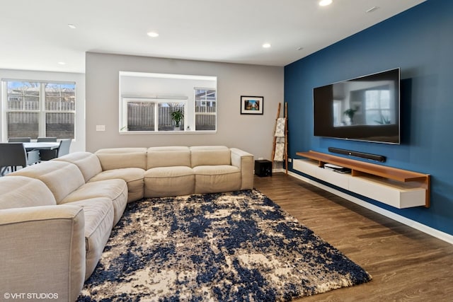 living room featuring recessed lighting, baseboards, and wood finished floors