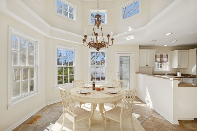 dining room with visible vents, a notable chandelier, recessed lighting, baseboards, and a towering ceiling