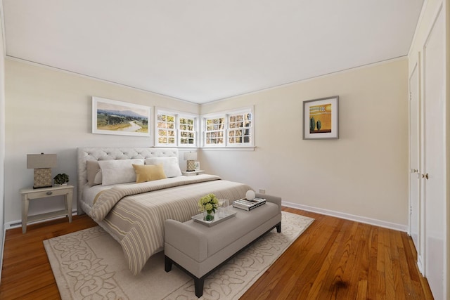 bedroom featuring light wood-type flooring and baseboards