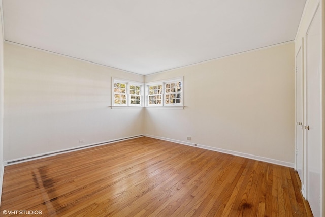 unfurnished room with baseboards and light wood-style flooring