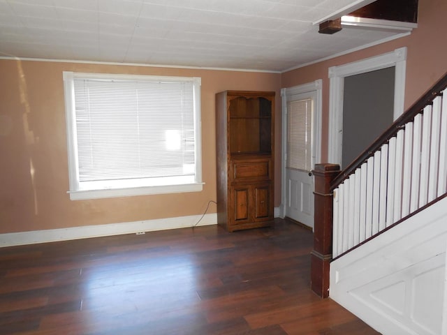 foyer with dark wood-style floors, stairs, baseboards, and ornamental molding