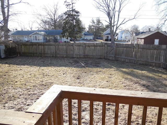 view of yard featuring a fenced backyard and a residential view