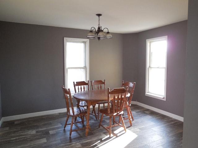 dining room with baseboards, an inviting chandelier, and dark wood-style floors