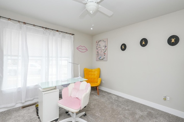 carpeted office space featuring visible vents, baseboards, and ceiling fan